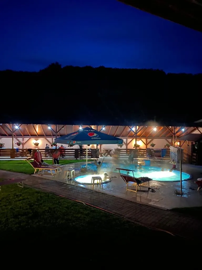 Piscina și pensiunea iluminate noaptea